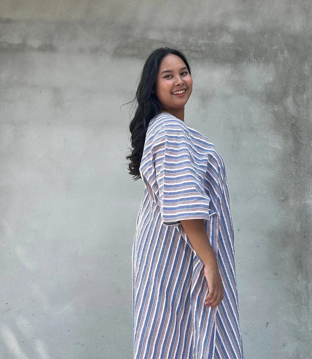 smiling curvy, plus size woman wearing striped caftan