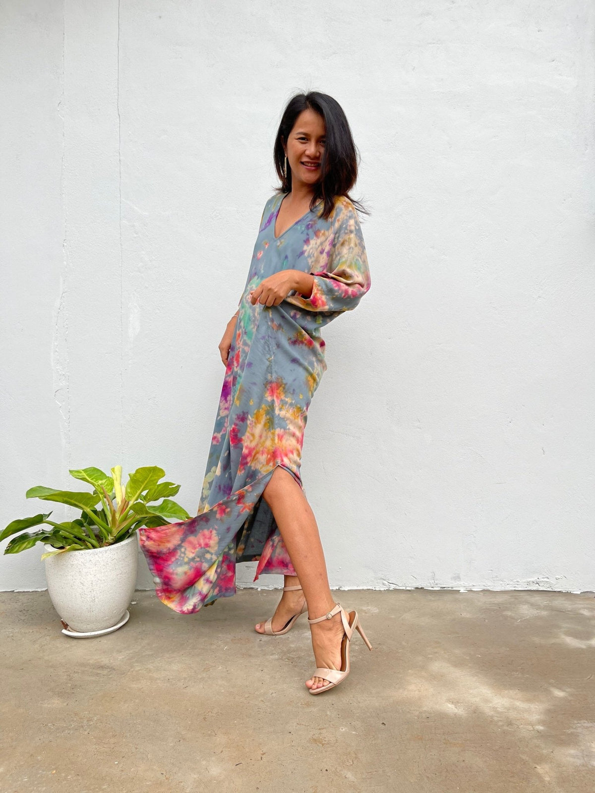 Model wearing the Camila Kaftan in Dark Gray Rainbow Tie Dye, side view showing the side slit